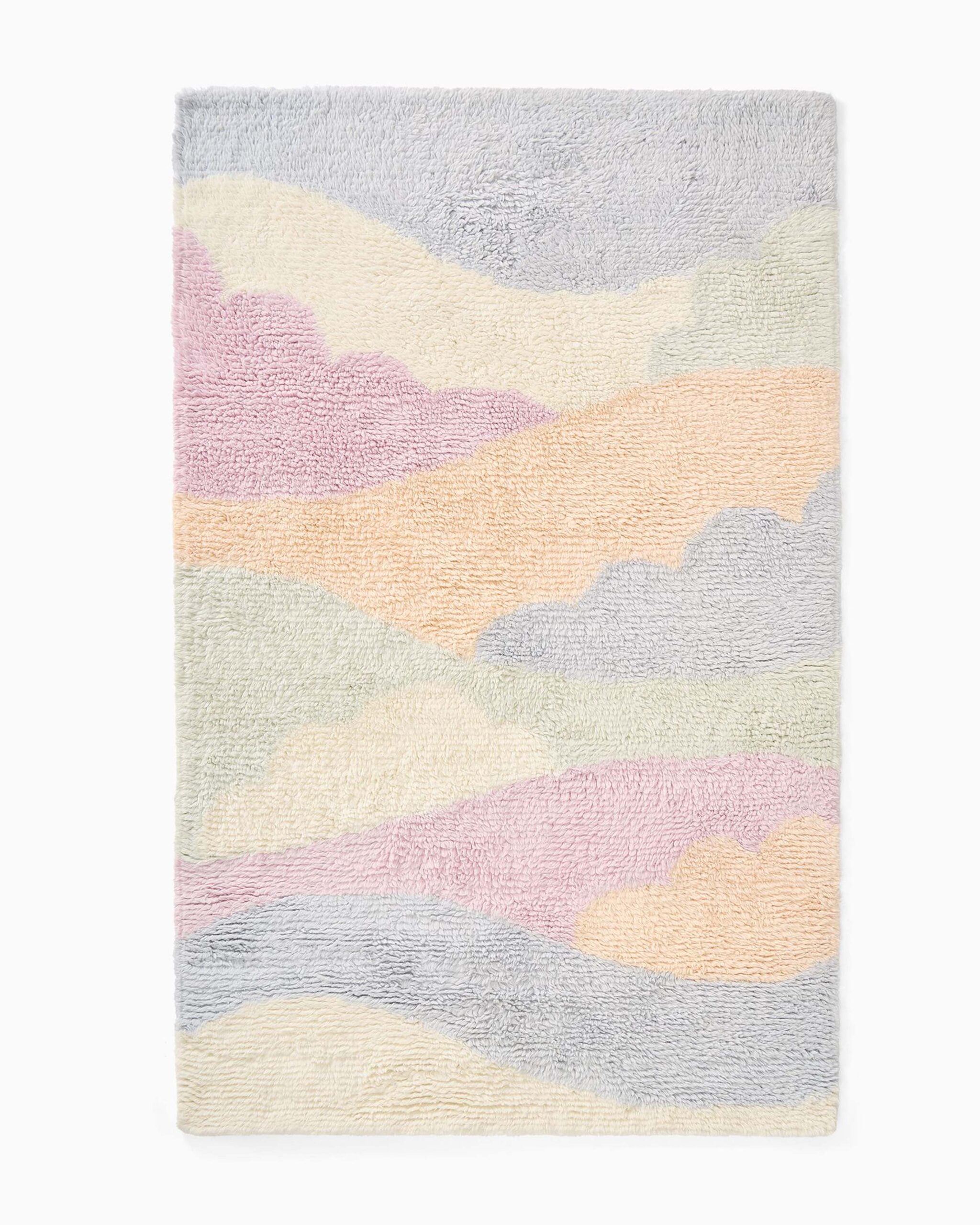 Pastel abstract hand-tufted wool kids rug with soft wave design.