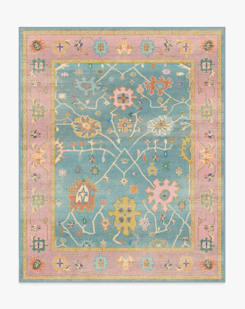 Luxury vintage printed area rug in pastel blue and blush pink tones with traditional floral motifs and ornate heritage border detailing for elegant modern interiors.