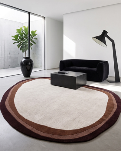 Pebble Gradient hand-tufted wool rug with organic pebble shape, soft gradient tones, and plush textured surface for modern luxury home decor.