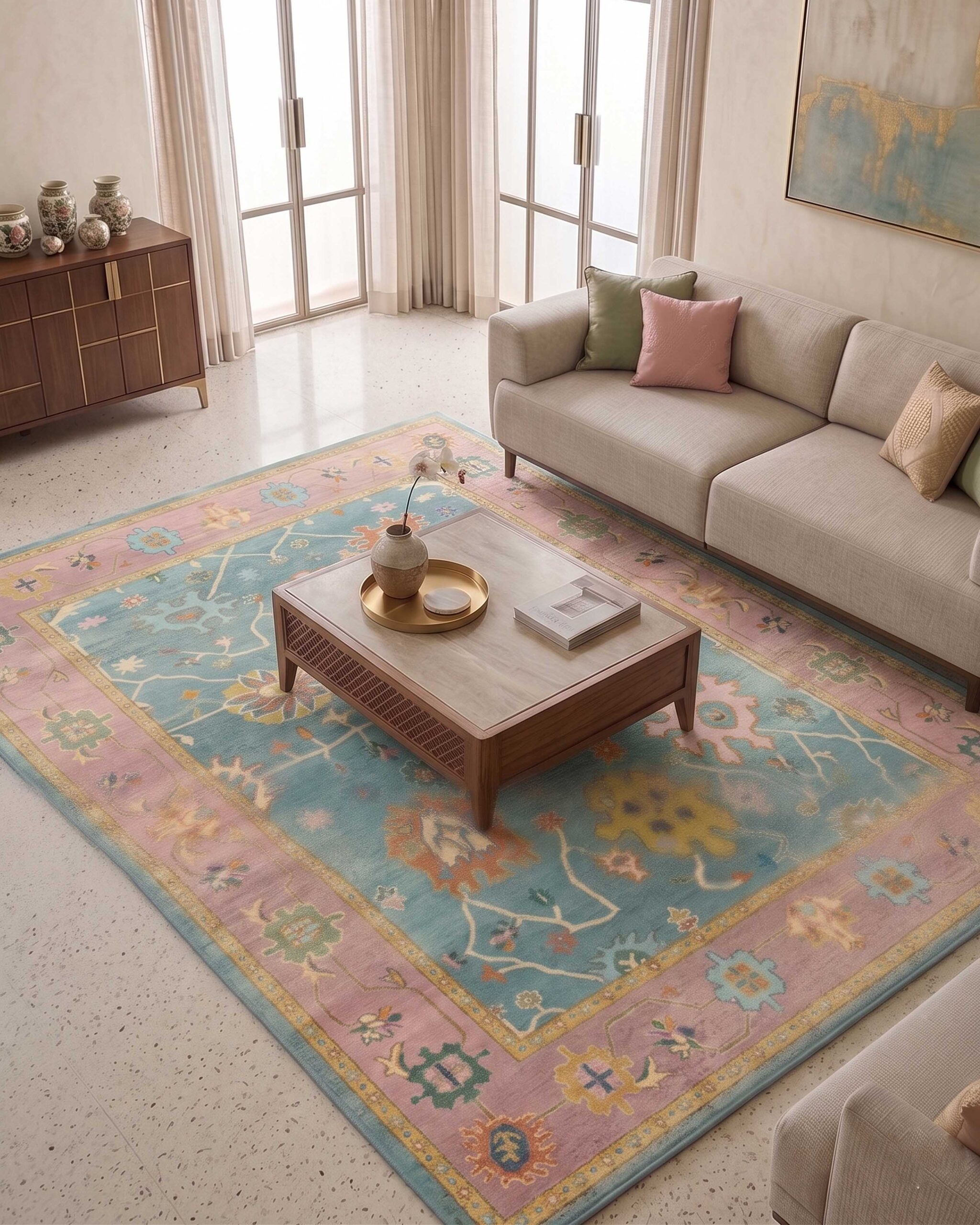 Luxury vintage printed area rug in pastel blue and blush pink tones with traditional floral motifs and ornate heritage border detailing for elegant modern interiors.